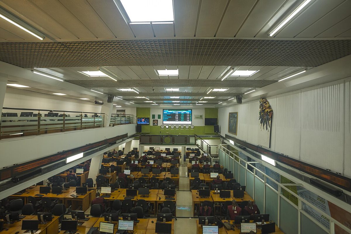 The trading floor of the Nigerian Stock Exchange in Lagos, with dealers at rows of terminals beneath a board of top gainers