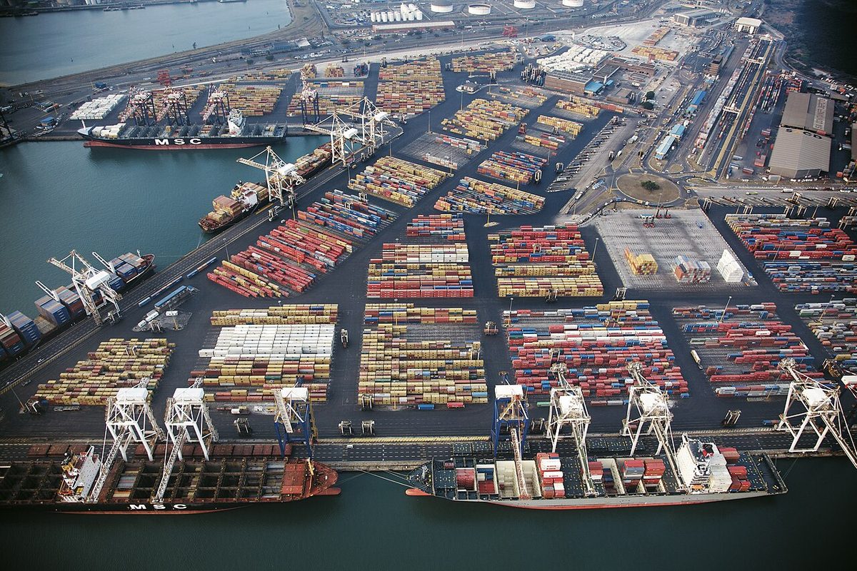 Aerial view of the container terminal at the Port of Durban, with ship-to-shore cranes, stacked containers and berthed container ships