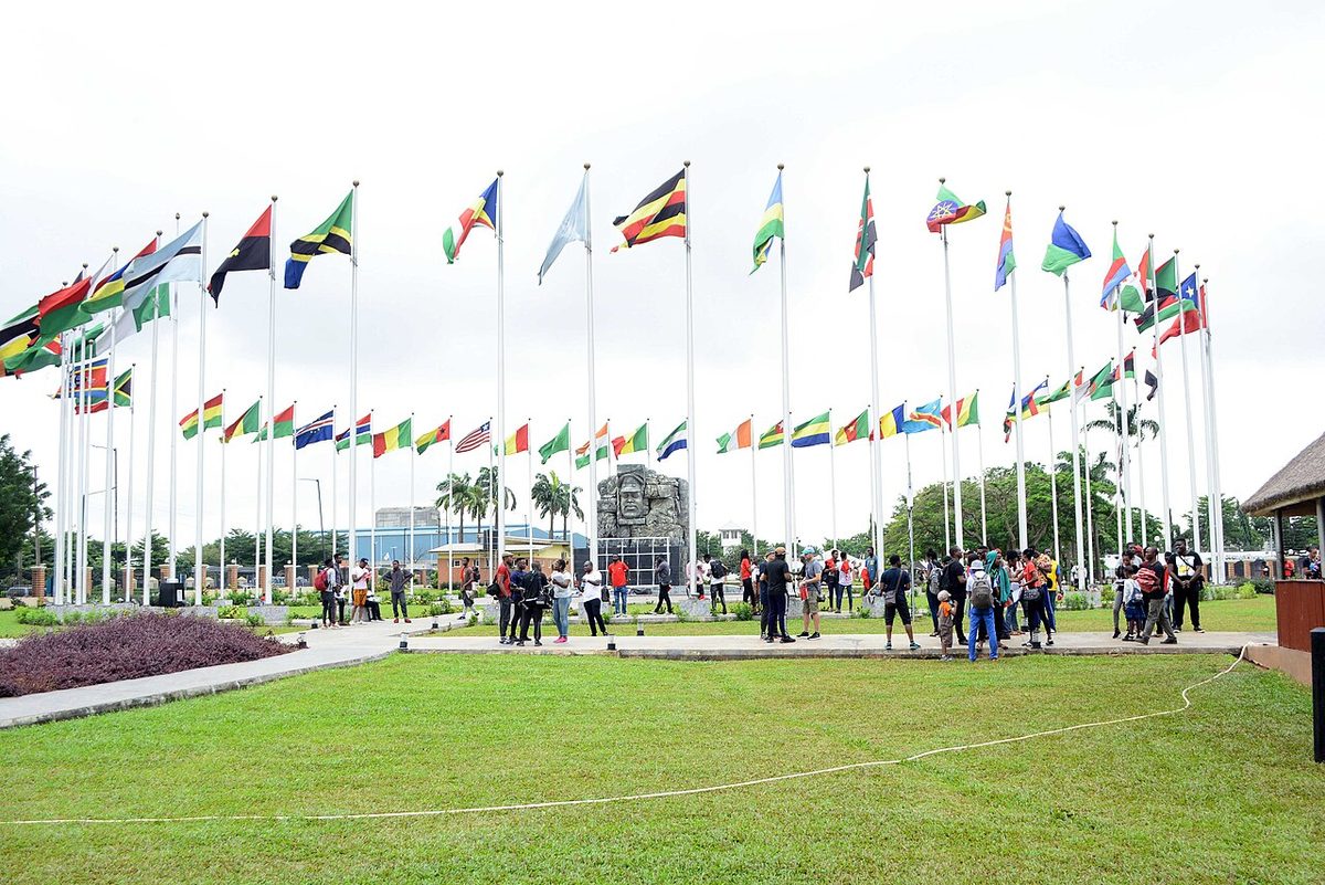 The flags of African nations flying on a ring of flagpoles at a heritage site in Nigeria