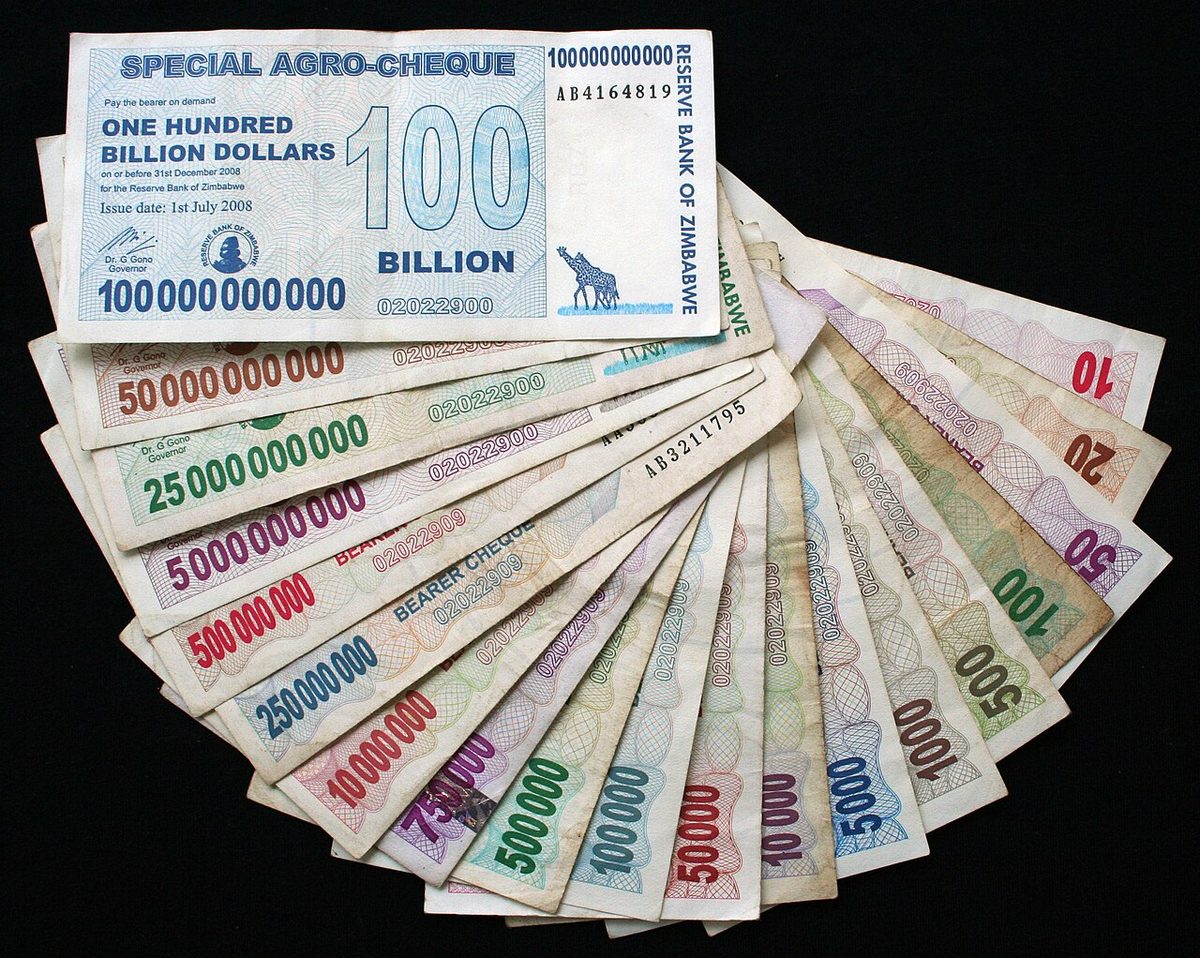 A fan of Zimbabwean bearer cheques from 2007 and 2008, from ten dollars up to a one-hundred-billion-dollar agro-cheque